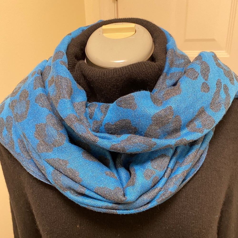 Vibrant blue leopard print scarf featuring black animal print pattern